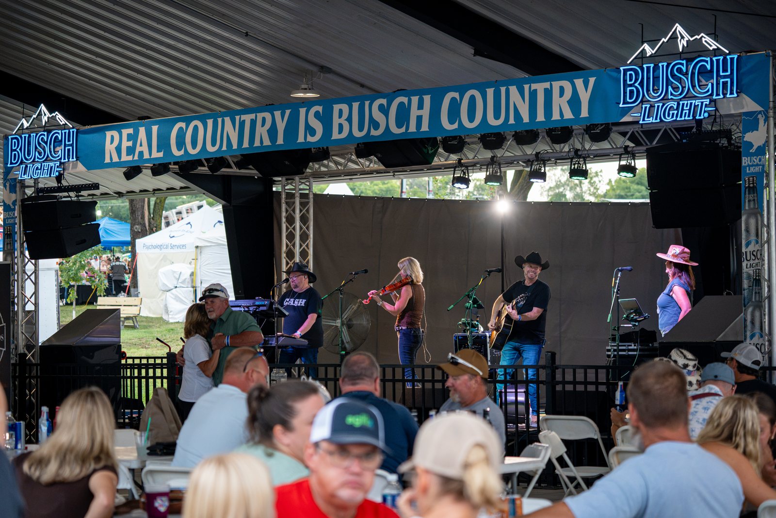 Wide festival shot — full crowd watching the band on the main stage