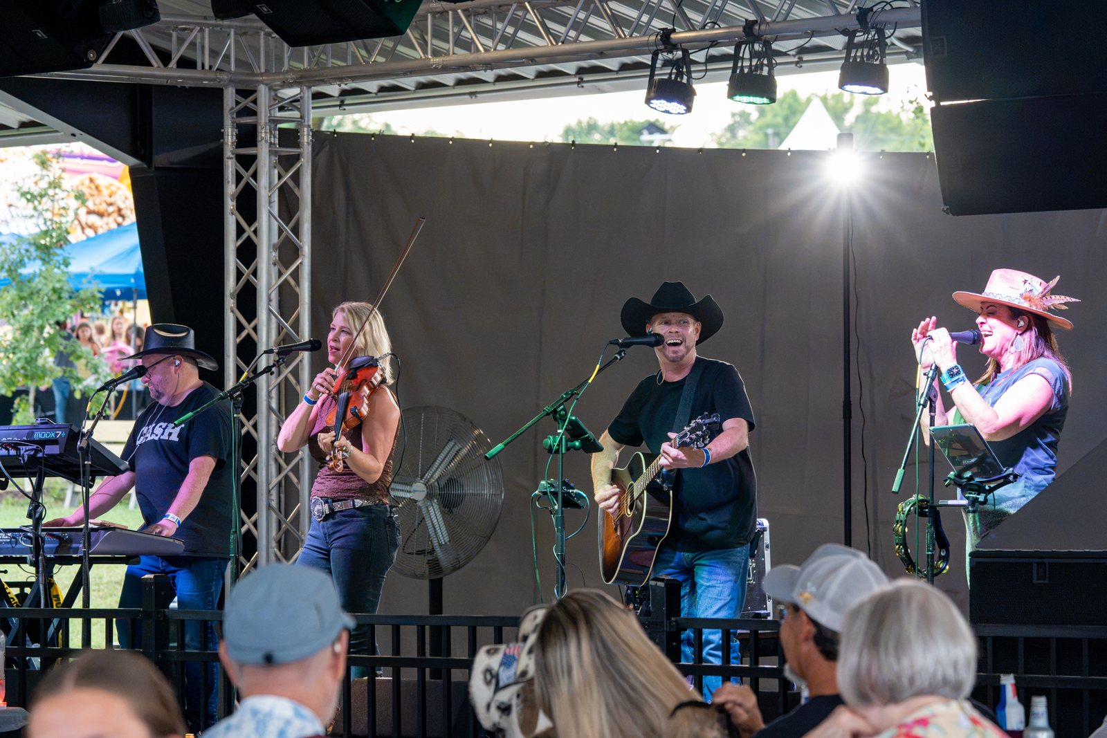 Country Roads & Friends lineup on a festival stage with the crowd up front